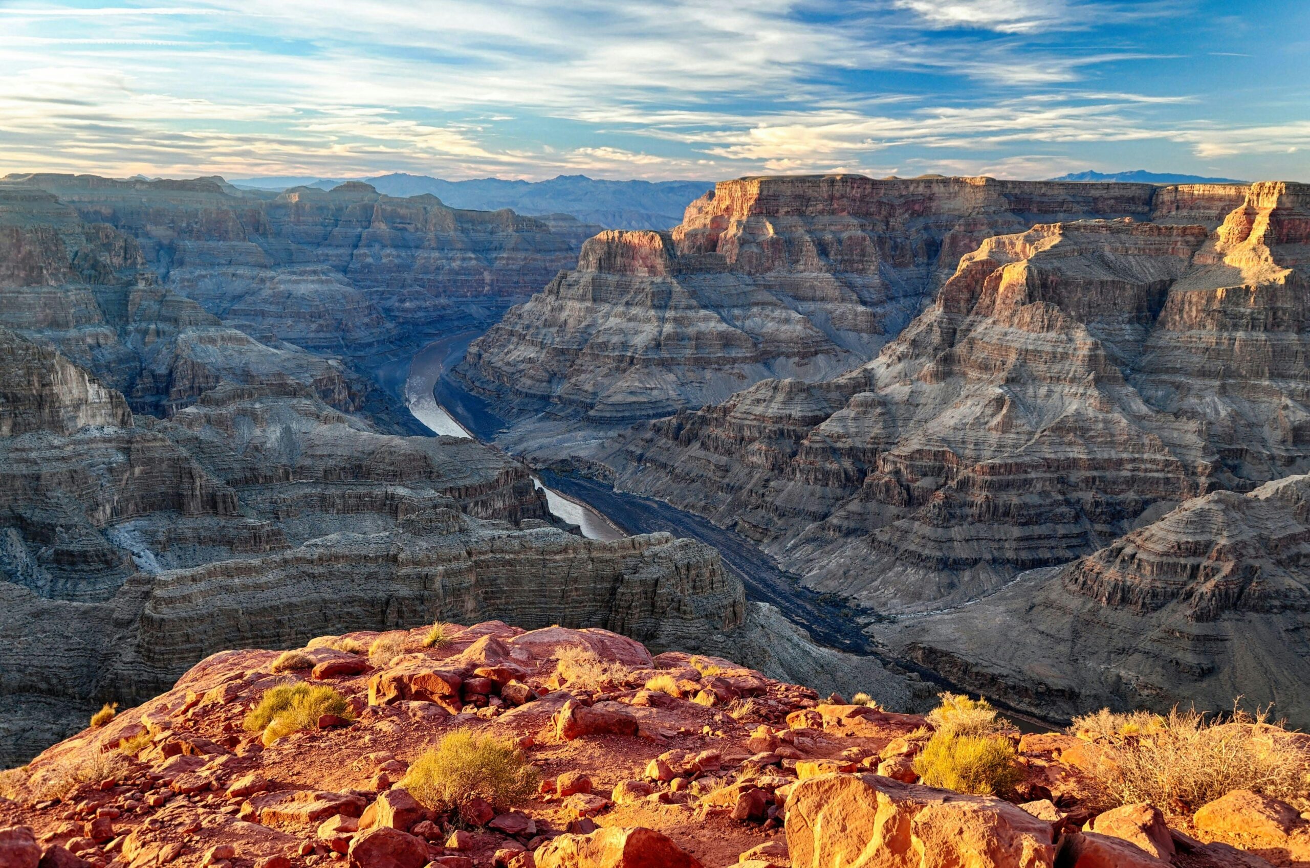 Deep layered red rock formations of the Grand Canyon during a dramatic orange sunset