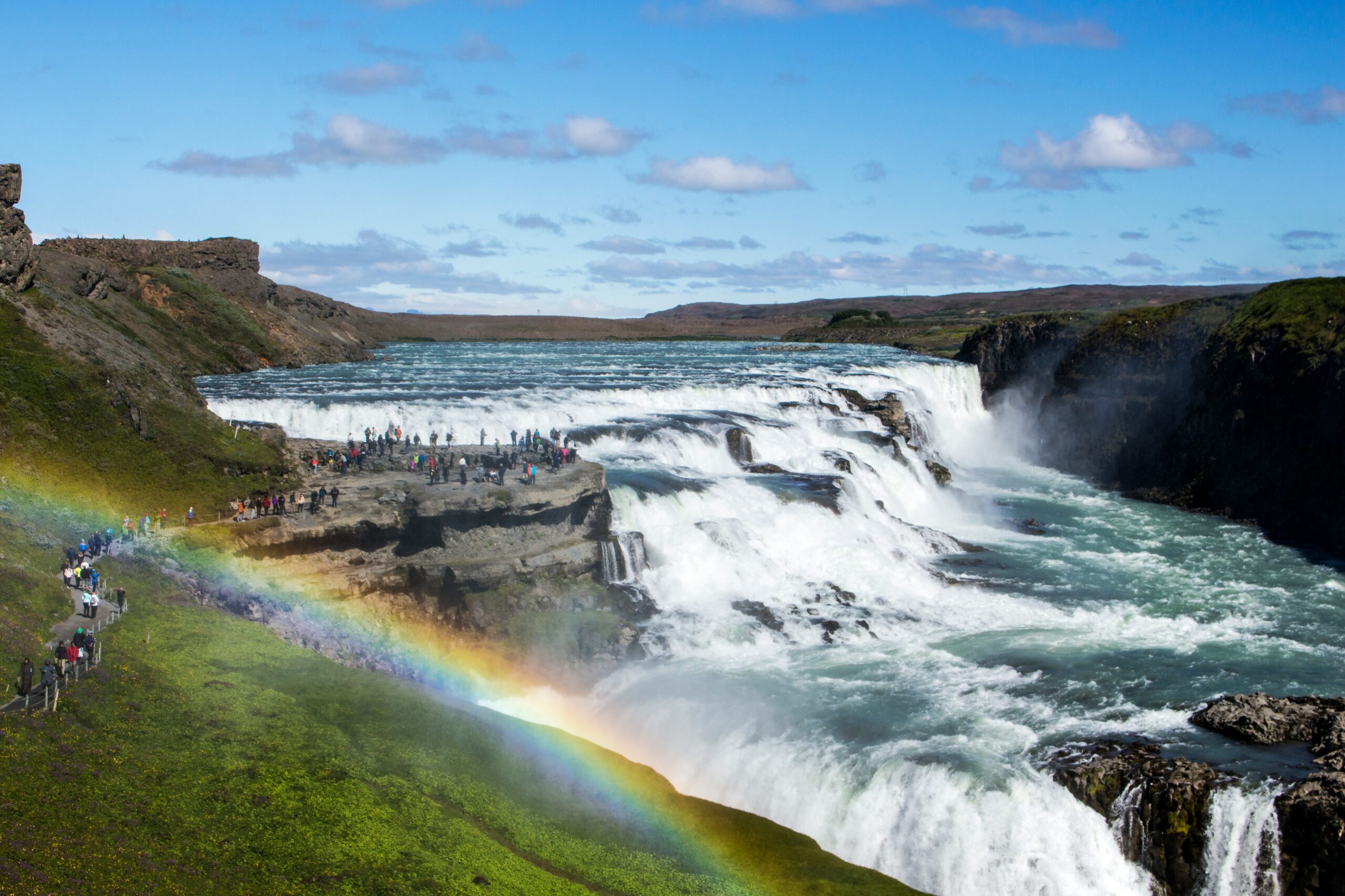 Massive Gullfoss waterfall cascading down deep rocky canyon cliffs in Iceland